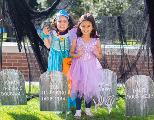 Two little girls dressed in trick or treat outfils at the Meadows Museum Halloween day