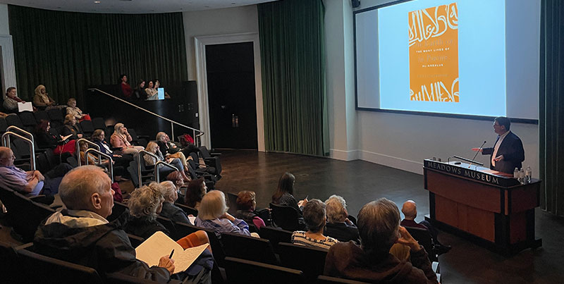 View of the Meadows Auditorium with people in audience seen from the side